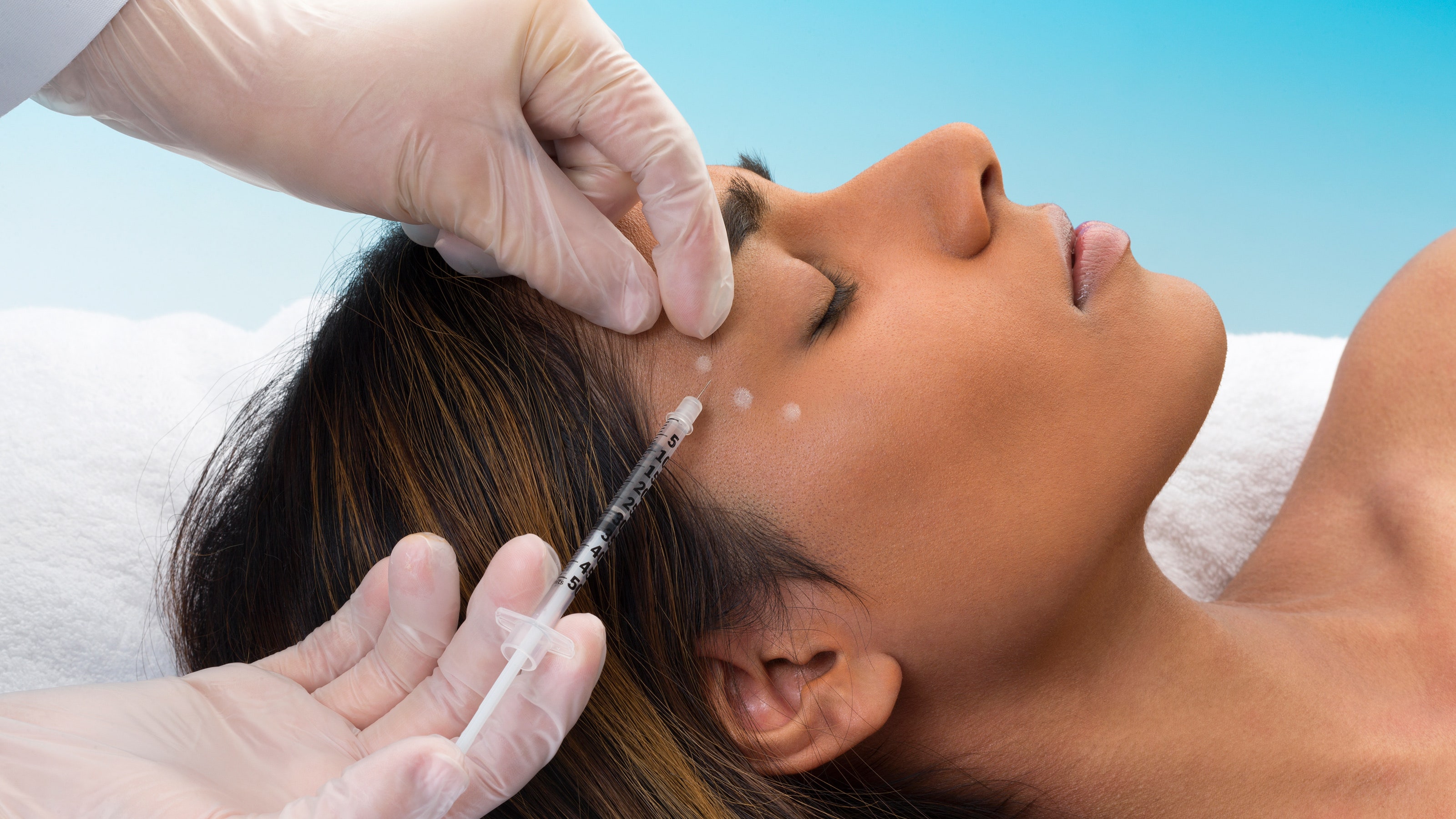 Botox injection being administered to forehead area